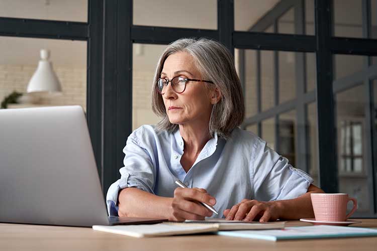 Studying Older women working at a laptop
